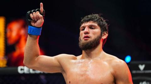 Timur Khizriev celebrates after beating Gabriel Braga in August 2024