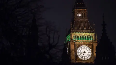 A shot of the clock face on the Elizabeth Tower taken at night. The Ayrton Light can be seen at the top of the tower